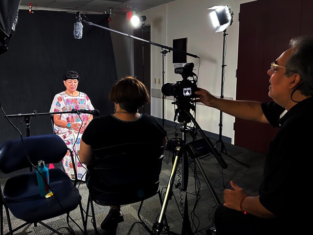A woman gives a recorded interview for the Voces Oral History Project.