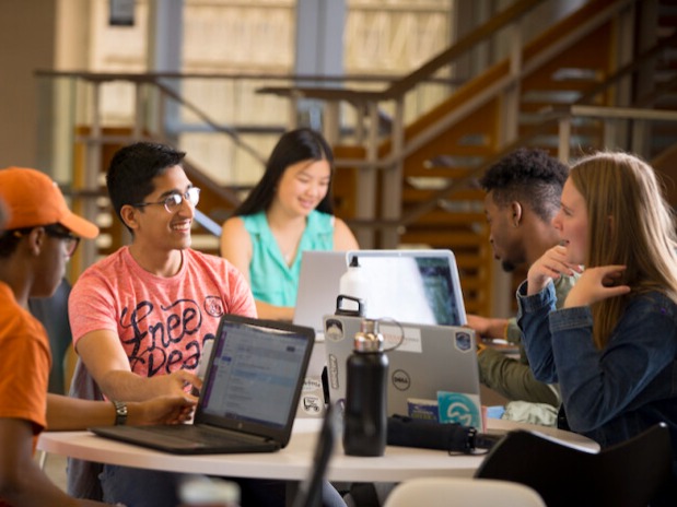 students in discussion with a professor 