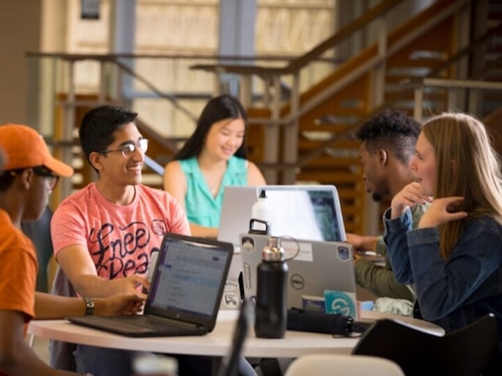 students in discussion with a professor