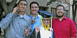 Graduate Fatima Bhuriwala with friends who share her Longhorn pride and talk on the phone at the same time