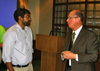 Dr. Shingavi talking with Dr. Charles Roeckle from the Office of the President