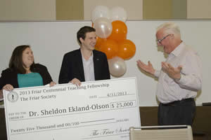 Students present the Friar award to Dr. Sheldon Ekland-Olson in class. Photo by Marsha Miller.
