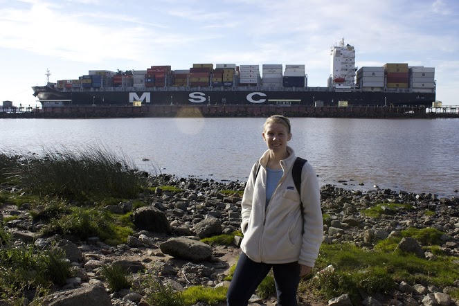 Lauren stands at the edge of the River Plate in the Reserva Ecológica as a cargo ship enters the Port of Buenos Aires