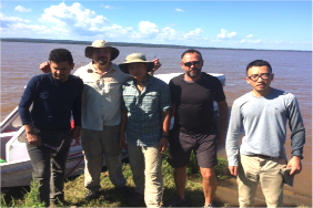 The large rivers team standing on the bank of the Amazon River after the acoustic Doppler and side-scan cross-sectional survey.