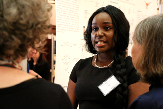 Zaria El-Fil, Psychology Major and Digital History Intern, describes her research project and poster to Profs. Julie Hardwick and Jacqueline Jones. El-Fil worked with Prof. Berry on her project.